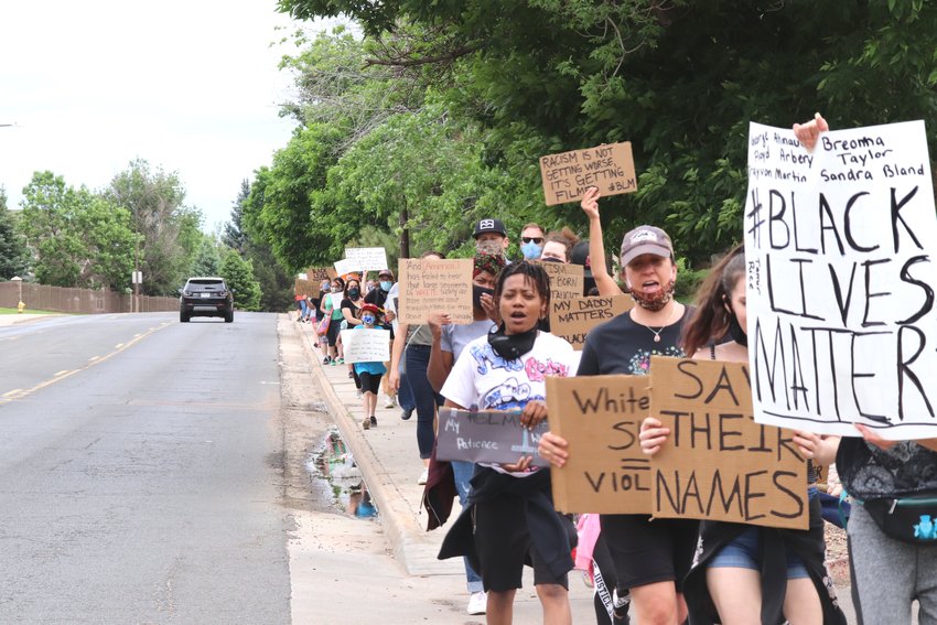 A group of 65 marchers protesting for racial justice walk down Community Center Drive from E.B. Rains Park to the city police department June 6.